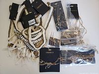 Overview of the Forever 21 costume jewelry including necklaces, braided pieces and earrings with original tags and packaging visible