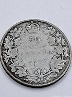 Reverse side of 1917 Canadian 50 Cent silver coin featuring maple leaf wreath, crown, denomination, country, and date.
