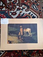 Photo showing the mounted print of "In From The Night Herd" on a carpeted floor.