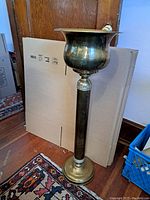 Full view of the tall brass jardiniere on pedestal.