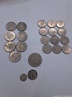 Collection of 23 Canadian coins showing both sides, various sizes and designs.