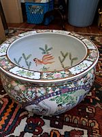 Oblique view from above showing the wide rim decorated with segmented floral bouquets outlining the top opening of the pot.