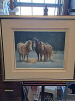 Framed oil on canvas painting showing three horses in a winter setting, titled 'Three Friends'.