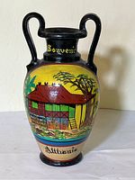 Front view of hand painted ceramic vase with two handles, depicting traditional Philippine house scene and text