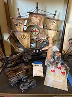 Model ship, windmill, and assorted knick knacks on shelf
