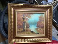 Frontal photo of framed landscape oil painting showing composition and frame details