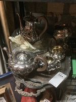 Tea pot, coffee pot, creamer, sugar bowl on footed serving tray with ornate handles and edges.