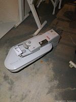 Photo of Singer CSP-1 Magic Steam Press on concrete floor showing front and side profile with control panel and handle lever visible.