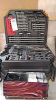 Closed view of Craftsman plastic drill bit cabinet with orange clasps and maker label.