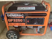 Front view of orange steel frame and wheels supporting the generator