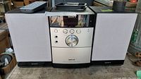 Sony MP3 micro Hi-Fi stereo system with remote and two speakers on wooden surface in garage