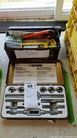 Mastercraft 12-piece tap and die set with utility cutters and other small tools inside a metal storage box.