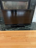 Front view of Samsung flat screen TV showing the screen and stand with no visible damage.