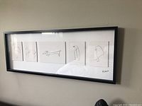 Front view of framed print showing five minimalist animal sketches in black line art with Picasso signature.