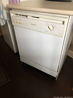 Front closed view of the white portable dishwasher showing exterior and control panel