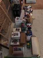 Wide view showing several stacks of loose football cards in boxes, some sealed in sets, others loose, together with multiple unopened packs arranged next to them.