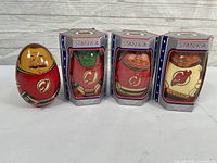 Four handmade wooden wobble dolls representing NHL New Jersey Devils players. One doll is outside box, three are boxed.