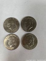 Front side of four Eisenhower one dollar coins showing President Eisenhower's profile and year 1971.