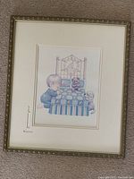 Framed illustration of a child kneeling at a bed with quilt and teddy bears, gold frame and double matted