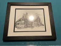 Photo of framed black and white house print showing overall condition and style of frame and matting.