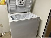 White Avanti chest freezer top open showing interior and two removable wire baskets