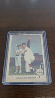 Front of 1959 Fleer Ted Williams baseball card, showing a posed photo of Ted Williams with a young ballplayer and text 'A Future Ted Williams?'.