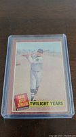 Front view of the 1962 Topps Babe Ruth Special Twilight Years baseball card inside a clear protective case, featuring Babe Ruth with bat and emblem.