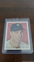 Front of 1982 Joe DiMaggio baseball card showing portrait illustration in Yankees cap and uniform