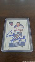 Front of hockey card showing Andy Bathgate in New York Rangers uniform with his autograph.