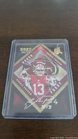 Front view of 2022 Brock Purdy rookie card showing player images and autograph in protective plastic case.