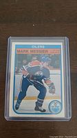 Front view of Mark Messier 3rd year hockey card in protective plastic case, showing action shot and branding.