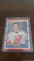 Photo of Martin Brodeur rookie hockey card in protective case showing front side featuring Brodeur in New Jersey Devils uniform.