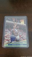 Front of Shaquille O'Neal rookie basketball card from the 1992-93 Ultra series inside a protective plastic sleeve, showing O'Neal going for a shot while guarded by a defender.