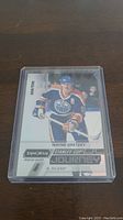 Front view of Wayne Gretzky hockey card showing him in Edmonton Oilers uniform, card numbered 302/999 from Synchro Stanley Cup Journey series.