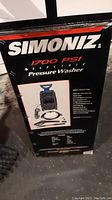 Box label showing Simoniz brand and 1700 PSI electric pressure washer with model S1700.