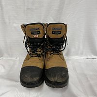 Front view of brown and black Dakota T-max steel toe work boots showing black laces, steel toe caps and branding on tongue.