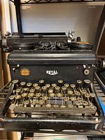 Front view of antique Royal typewriter showing keyboard and Royal logo on front.