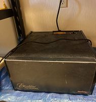Front view of the black Excalibur Food Dehydrator with power cord showing textured surface and overall rectangular shape.