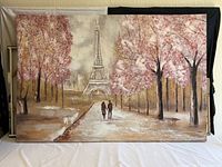 Full view of large canvas print showing Eiffel Tower and couple walking along the path with trees on either side.
