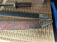 Top view of sword sheaths focusing on fabric texture and metal fittings