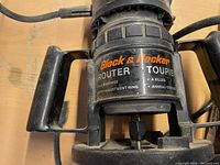 Close-up of Black & Decker router model 7604-04 with visible branding and adjustment features.