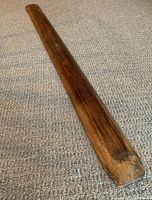 Top side view of long narrow rustic wooden trough showing weathered wood grain and aged finish.