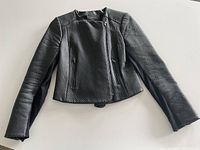 Front view of black leather jacket showing textured pattern and zippered pockets.