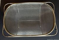 Top view of the stainless steel mesh strainer basket showing the fine mesh and rectangular shape with polished metal rim.