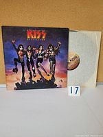 Vinyl LP album and inner paper sleeve with KISS Destroyer album cover showing four band members in costume and makeup.