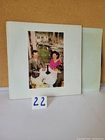 Front of gatefold vinyl sleeve showing family scene.