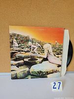 Front and back of vinyl album sleeve showing iconic artwork of naked children climbing stone steps with an orange sky background.