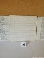 Front cover of Pink Floyd The Wall vinyl LP with white brick wall design.
