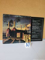 Front of the gatefold vinyl LP cover showing Battersea Power Station with black smoke from chimneys against a partly cloudy sky.