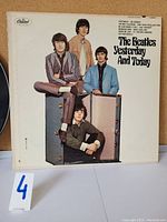 Front cover of The Beatles Yesterday And Today album showing the band members with luggage.